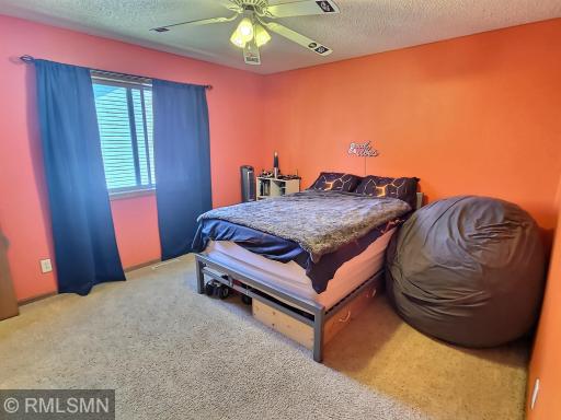 This spacious bedroom provides a ceiling fan, large walk in closet and carpet floors.