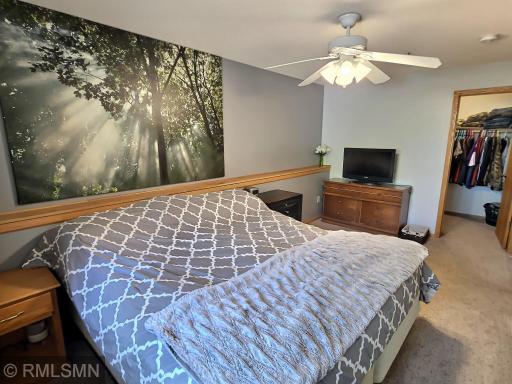 The expansive primary bedroom is placed in the lower level and delivers carpet floors, a ceiling fan and wonderfully sized walk-in closet.