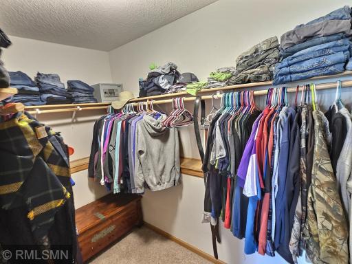 This generous walk-in closet is includes plenty of hanging options and still room for additional dressers if necessary.