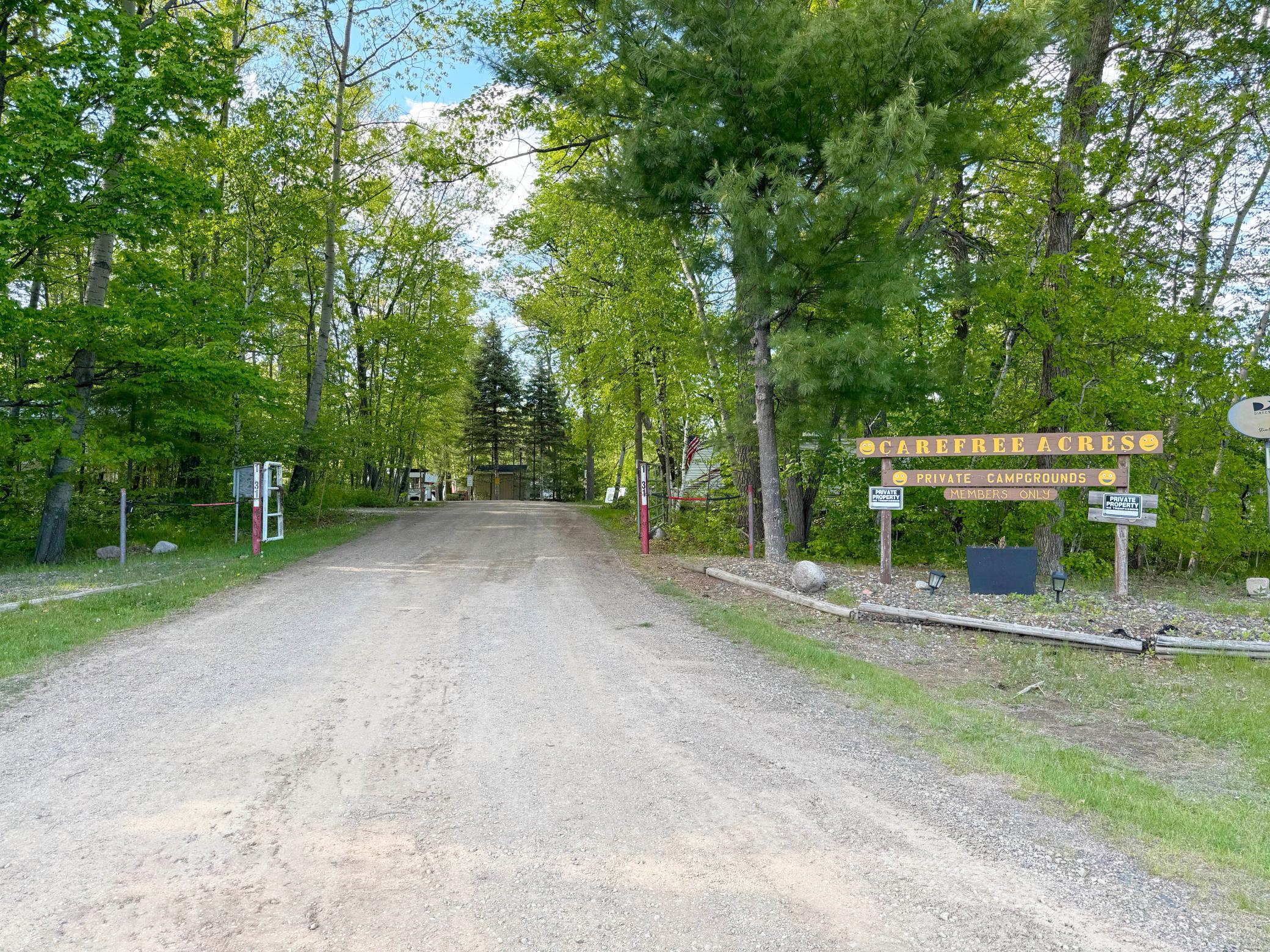 A shot of the campground's gated entrance and sign. You will own your own lot here, and the association fee includes electric and water and dumpster for sanitation disposal.