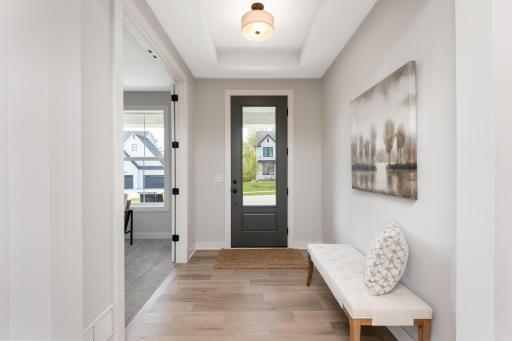 Greet family and friends in the spacious entryway. Features include a full view door, tray vault and quality wood flooring.