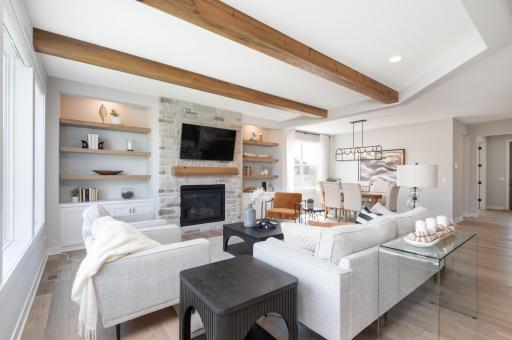 There are warm wood floors and useful extra storage here. There are custom blinds on the large windows that allow in wonderful natural light.