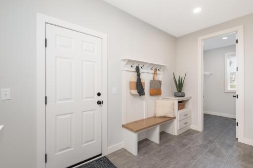 There is a spacious mudroom with huge walk in closet and handy half bath. Step out to the 4 car insulated and sheet rocked garage.