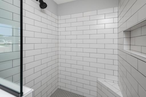 Very spacious ceramic tile walk in shower.