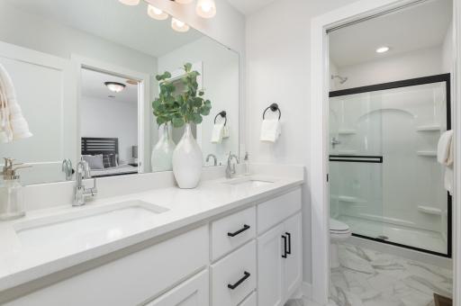 Bright upper level three quarter bath with double vanity is located off the hallway.