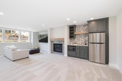 The lower level offers a huge family room with large windows for natural light, a gas fireplace, a wet bar and 3/4 bath for entertaining.