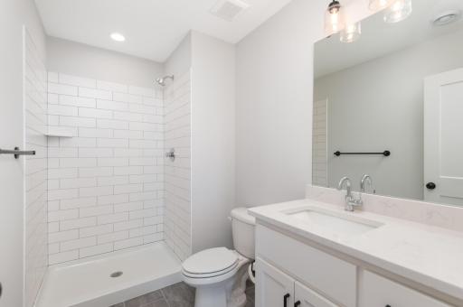 The lower level three quarter bath finished with ceramic tile.