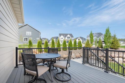 A door steps out from the informal dining to the maintenance free deck overlooking the beautiful landscaping and boulder walls.