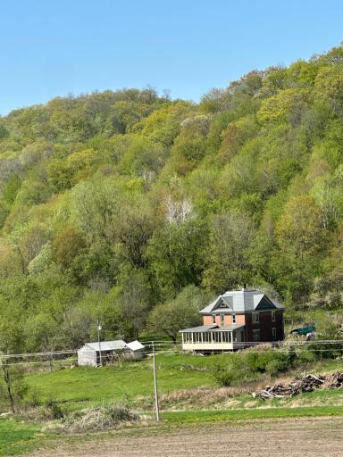Nestled in the countryside, this breathtaking valley is lush expanse of rolling greenery, dotted with lilac trees in bloom and a mix of maples, oaks, and evergreens.