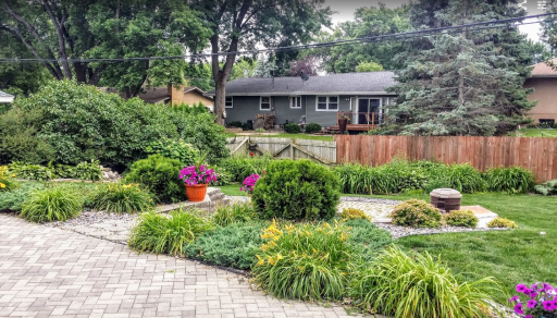 Private fenced back yard with gardens and paver patio and firepit