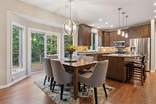 Entertainer's dream! The kitchen, dining, and family room flow seamlessly against the backdrop of the backyard.