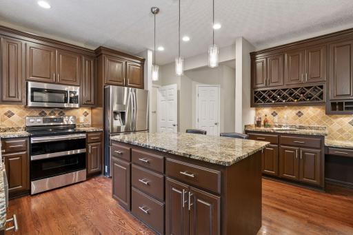 Tons of cabinetry storage and pantry. Enjoy the wine rack and desk workspace to the right.