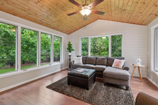 Generous 14 x 14 four-season porch reaches into the backyard.