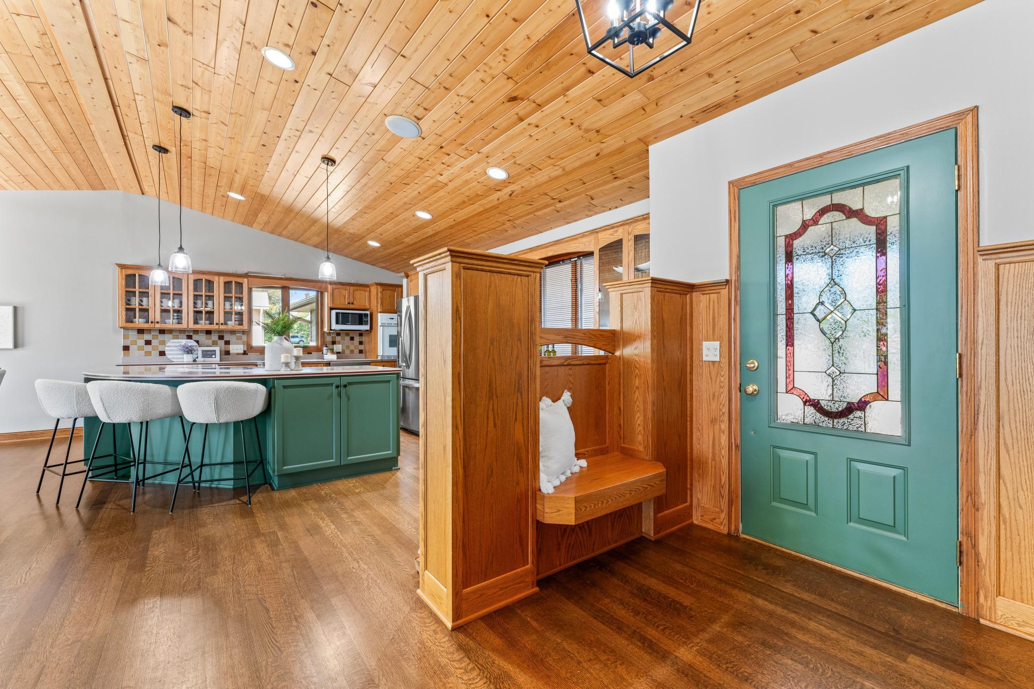 Front Entrance with Beautiful Stained Glass in the Door and Built-in Bench