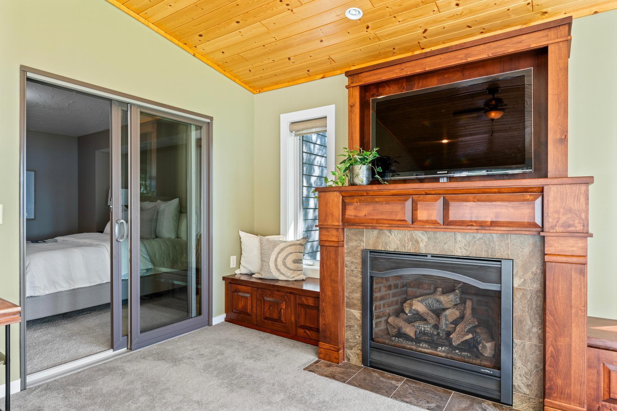 Beautiful Built-ins Around the Gas Fireplace. Notice the Primary Bedroom Opens to the Sunroom as Well!