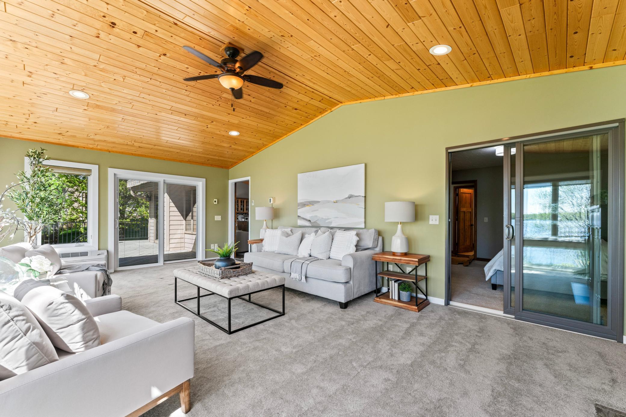 Sunroom opens to the Primary Bedroom. Notice the vaulted Pine Ceiling.
