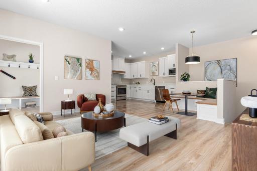 Open concept living with luxury vinyl floors, and built-in dining. Virtual staging.