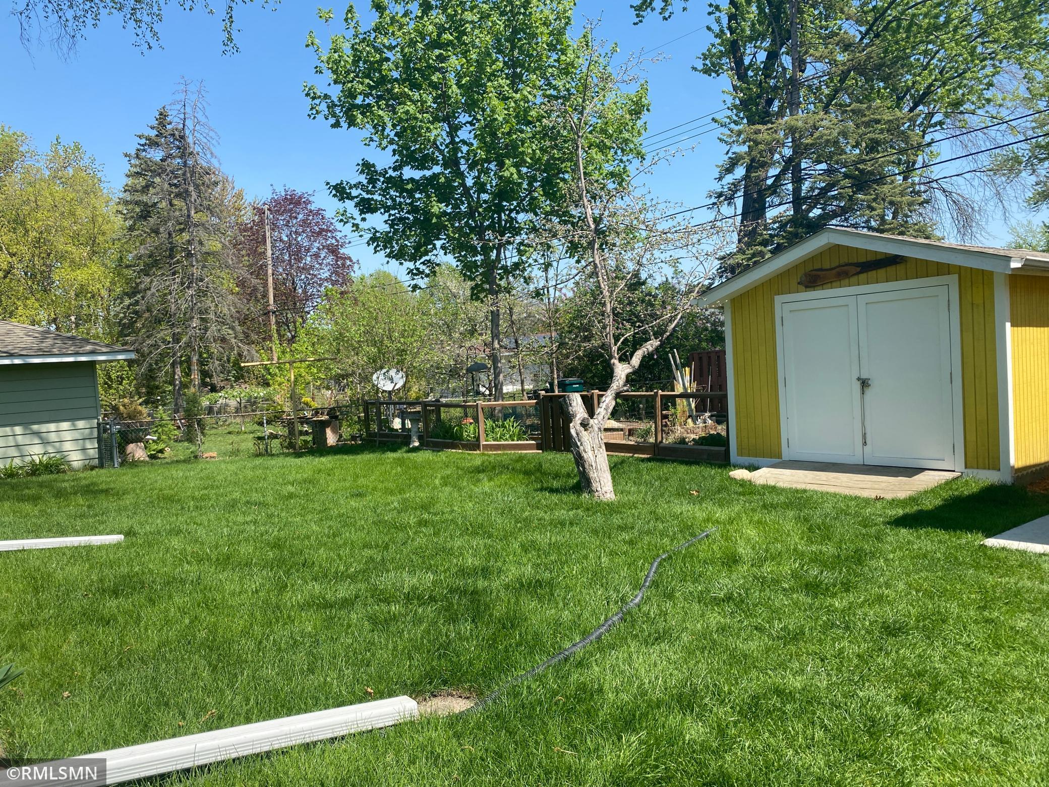 Fenced garden area next to shed