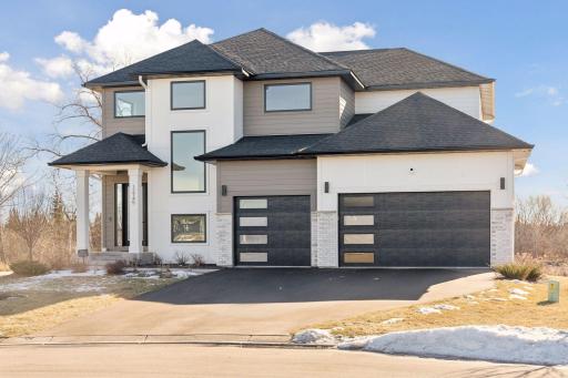 Modern exterior sconce lights and cement board siding in the front.