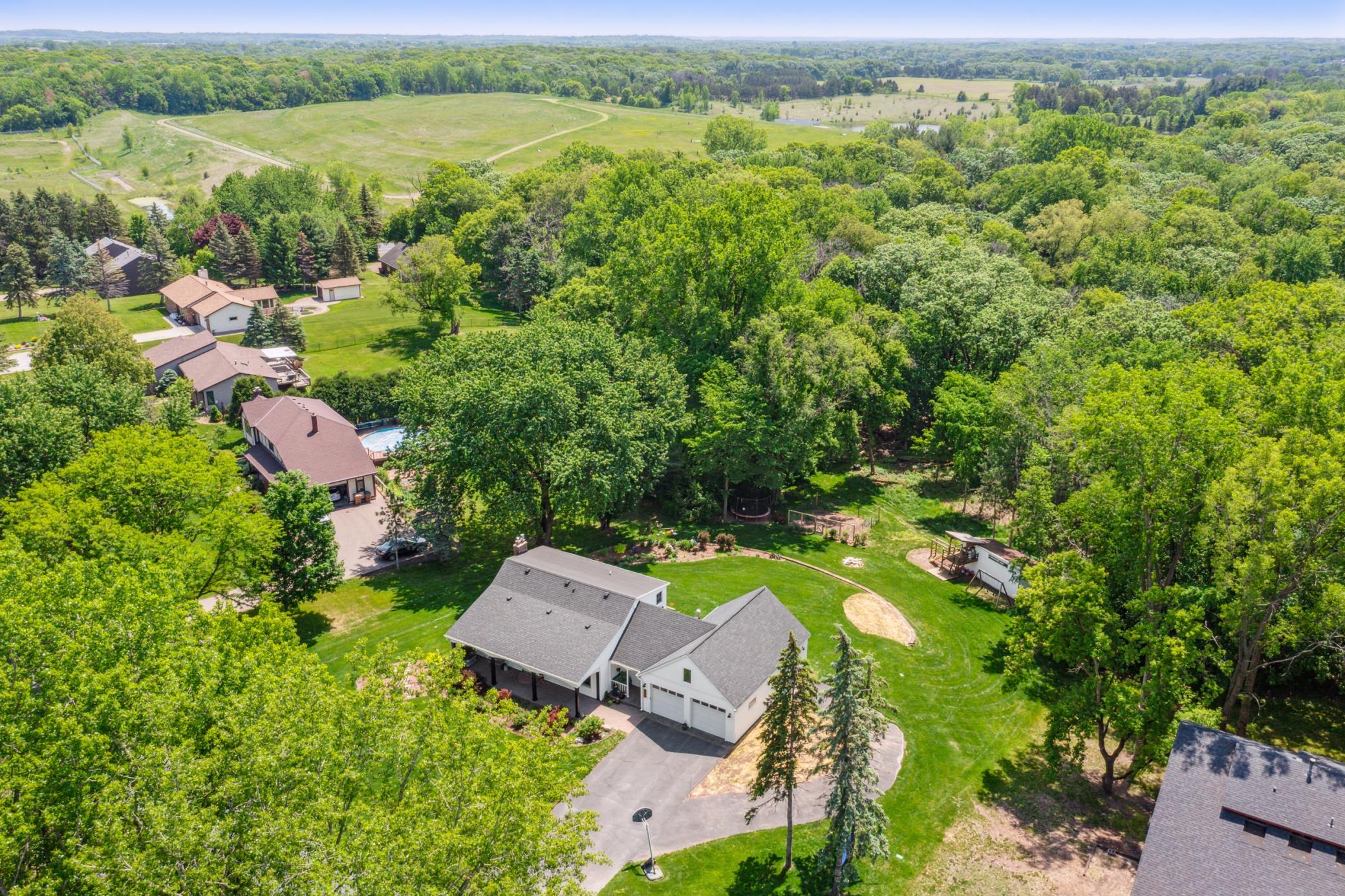 This home sits on just over an acre of land with mature trees, a golf course-like lawn, a beautiful retaining wall, large storage shed, and so much more!