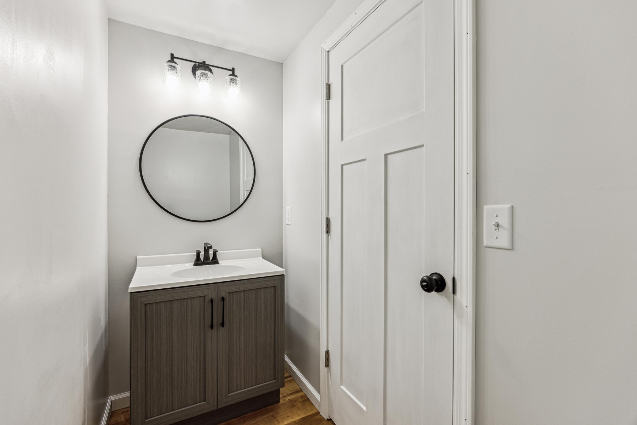 Freshly updated half bathroom on the lower level.