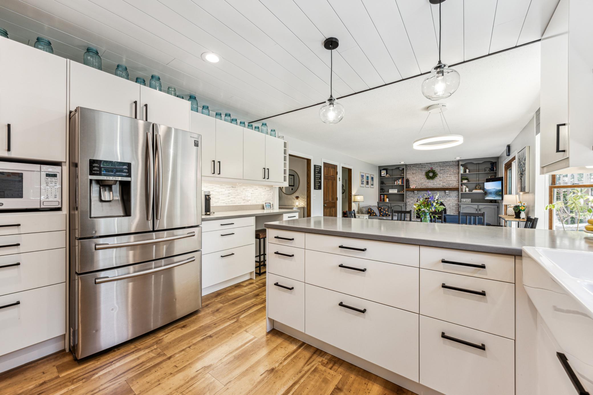 Beautifully updated and adorned with recessed and pendant lighting, sleek stainless steel appliances, tons of cabinet space and a timeless shiplap ceiling.