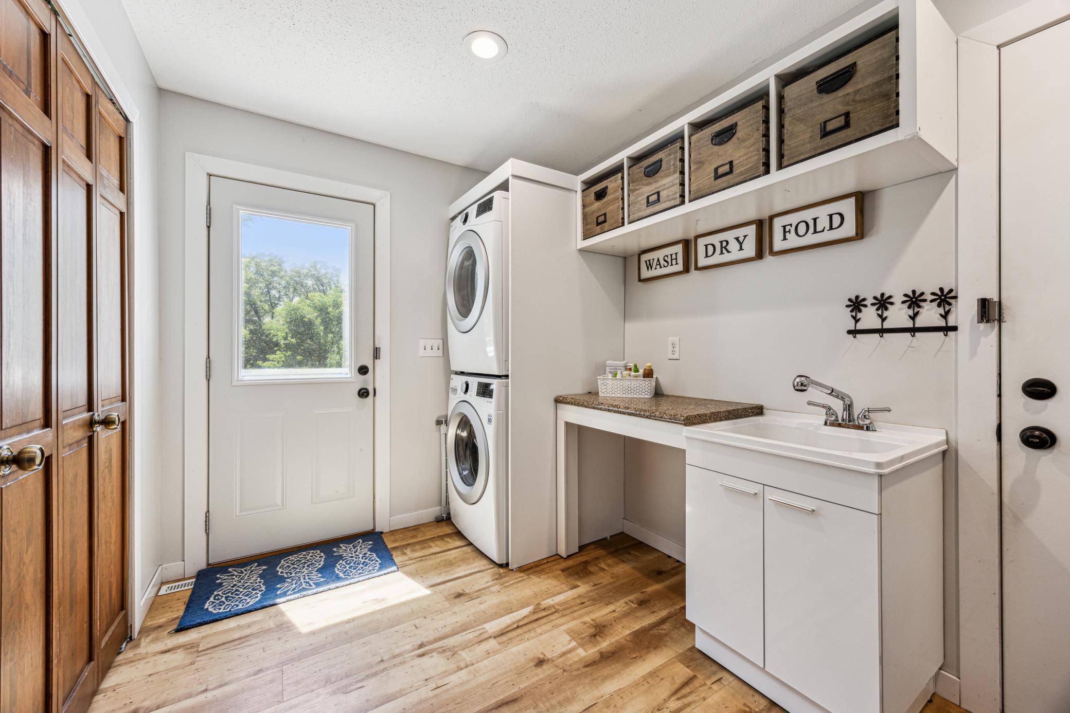 Tucked behind the kitchen, the laundry room functions as a convenient staging area between the garage, backyard, and front porch—helping keep your home neat and organized.