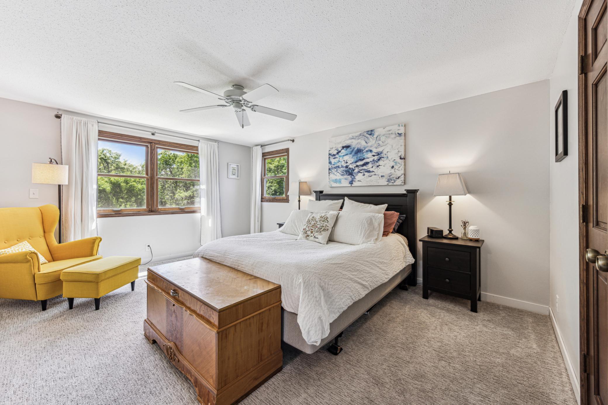 Facing south, the upper-level primary bedroom is filled with natural light. Cool tones and fresh carpet create a calm, comfortable space to rest your eyes.