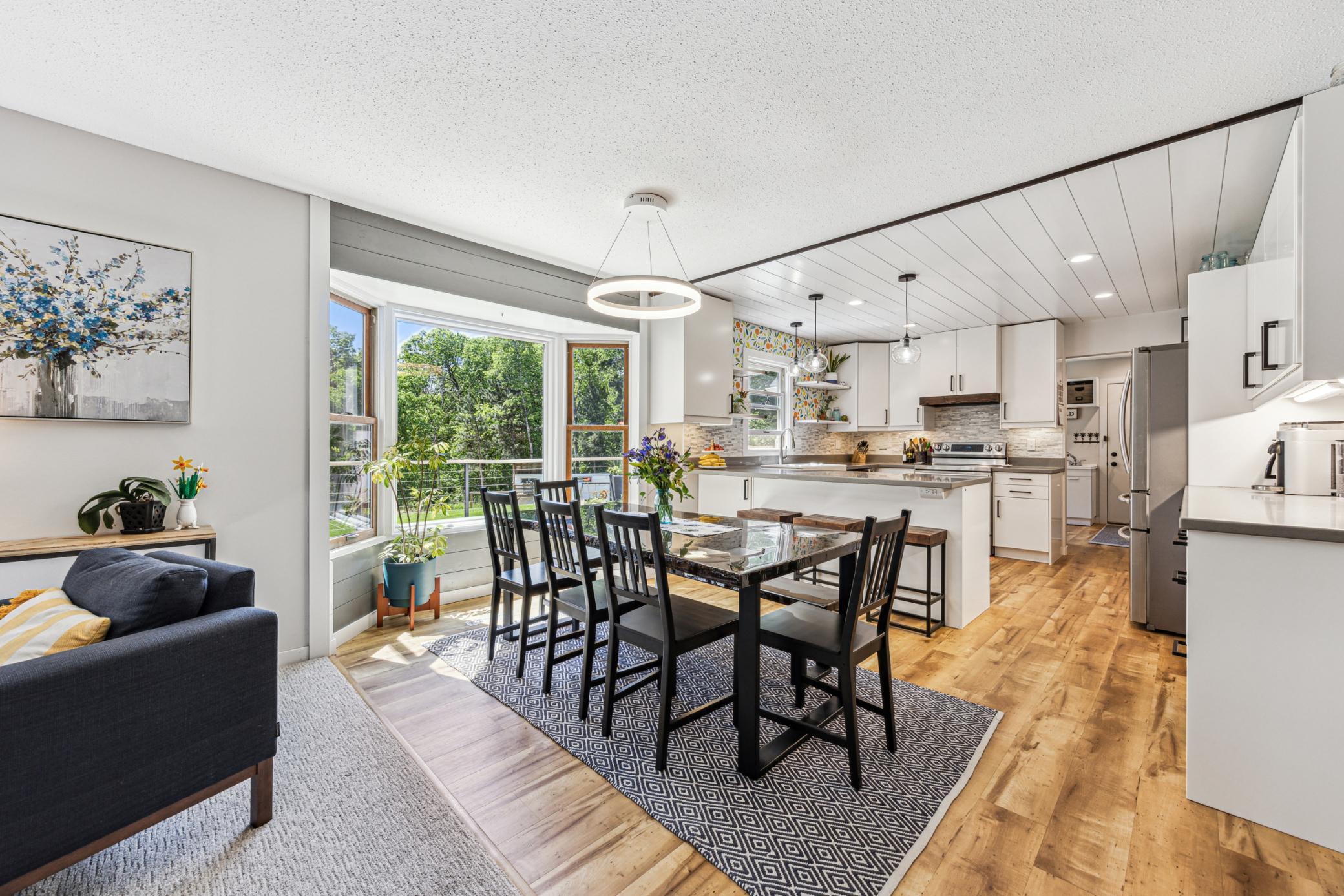The spacious dinette area features a large window that floods the space with an abundance of natural light.