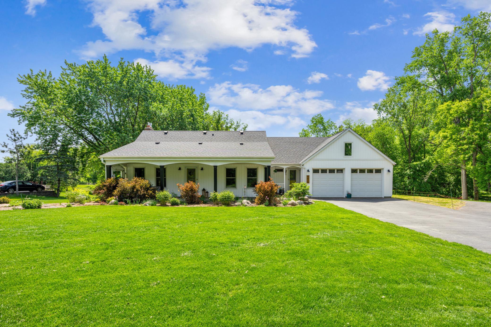 8875 42nd St, Lake Elmo
A stunning home featuring a covered brick patio, elegantly designed columns, gorgeous landscaping, and a meticulously maintained lawn.
