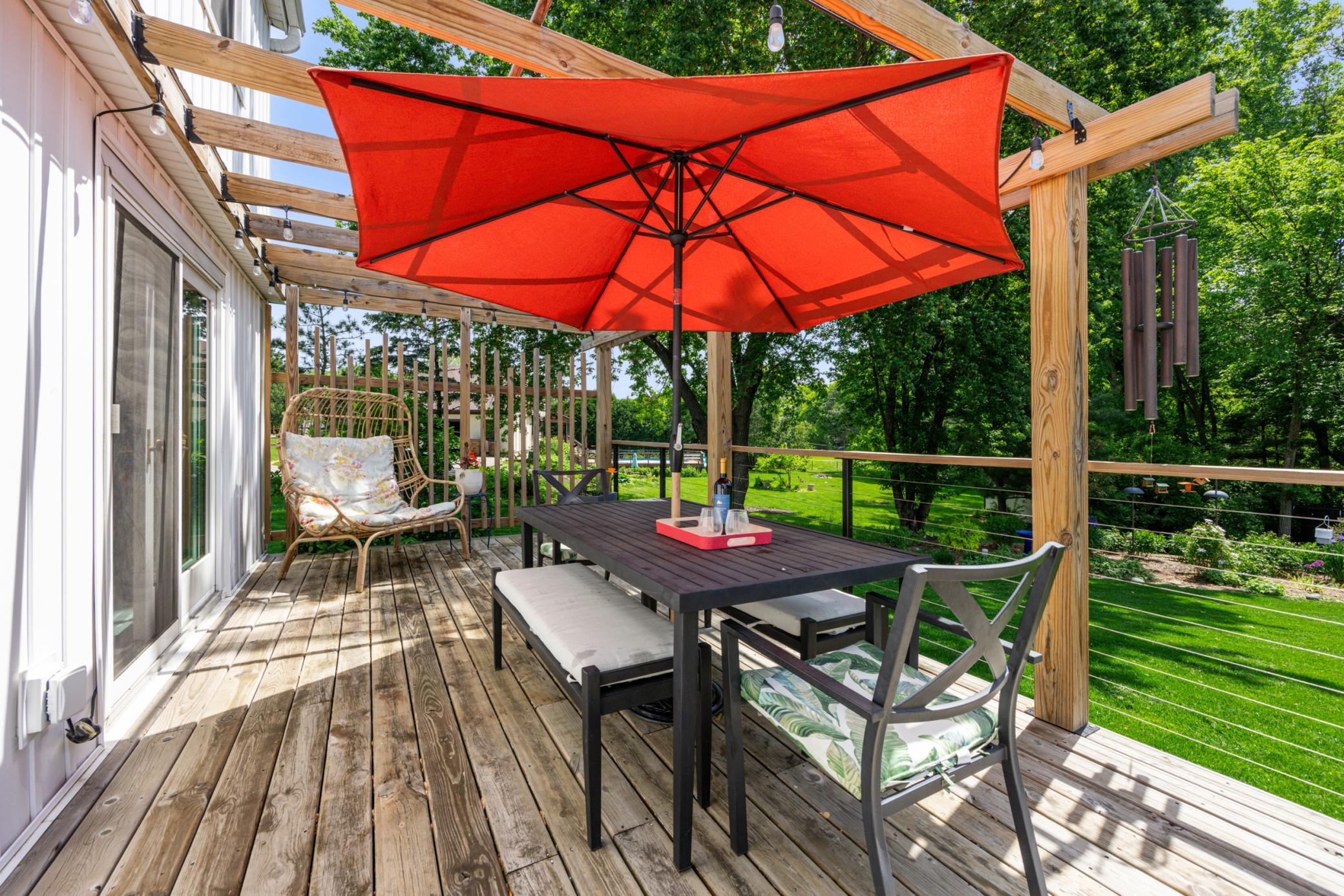 Nestled beneath the pergola is a charming outdoor dining area, ideal for al fresco meals, relaxing with a good book, or taking conference calls while working from home.