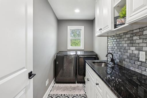 Upper level laundry room with utility sink