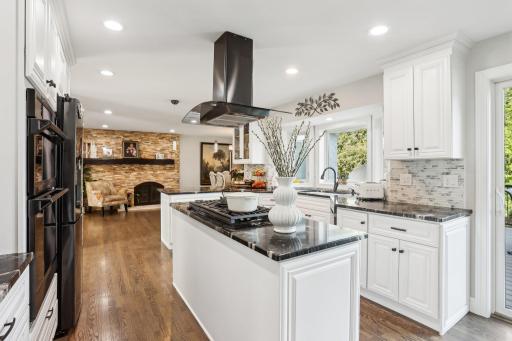 The gourmet kitchen boasts top-tier appliances, custom cabinetry, and a generous center island.