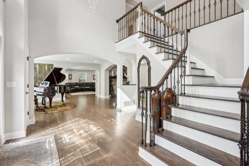 Main staircase features vaulted ceilings.