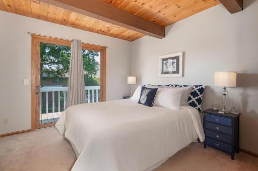 There is also a main floor bedroom and full bath. A sliding door steps out to a side deck with views of the lake and lawn.