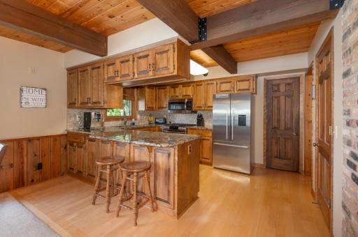 There are custom cabinets, upgraded stainless appliances and granite counter tops.