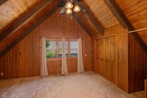 Upstairs you find a second large bedroom. The bedrooms have soaring vaulted ceilings finished with huge beams and wood.