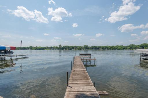 South facing dock with a bench and platform for greeting boaters. Sandy bottom and nice level area at lakeside for entertaining.