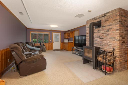 The walkout lower level provides a family room with wood burning stove and a bedroom or office with lake view!
