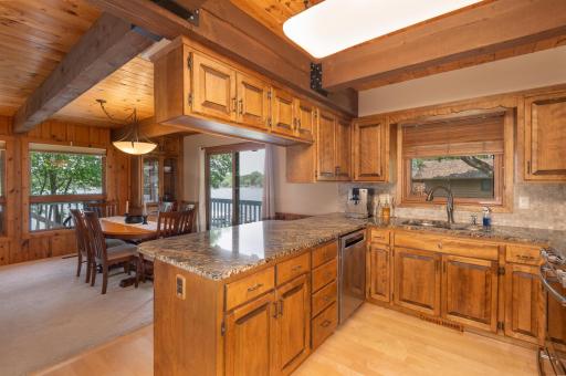 Have a quick meal at the breakfast bar or set out a buffet for your lakeshore gathering. The beam ceiling and wood floors are beautiful!