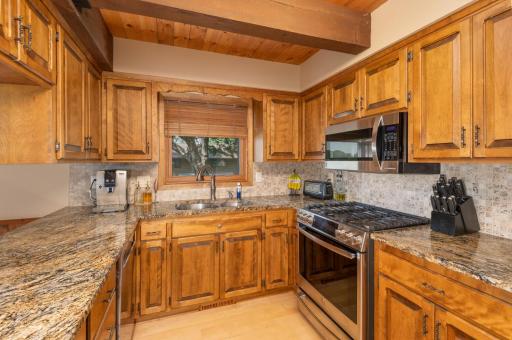 The kitchen offers plenty of cabinetry and counter space for meal preparation. A newer window has a lake view from the sink!