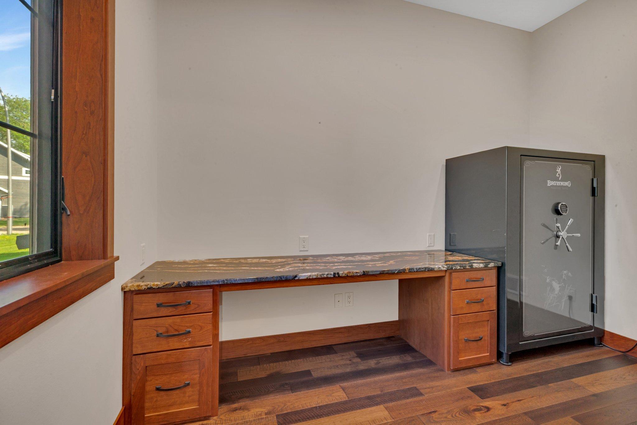 Office featuring a custom-built desk, offering a sleek and functional workspace with plenty of storage.