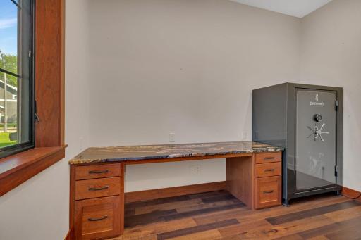 Office featuring a custom-built desk, offering a sleek and functional workspace with plenty of storage.