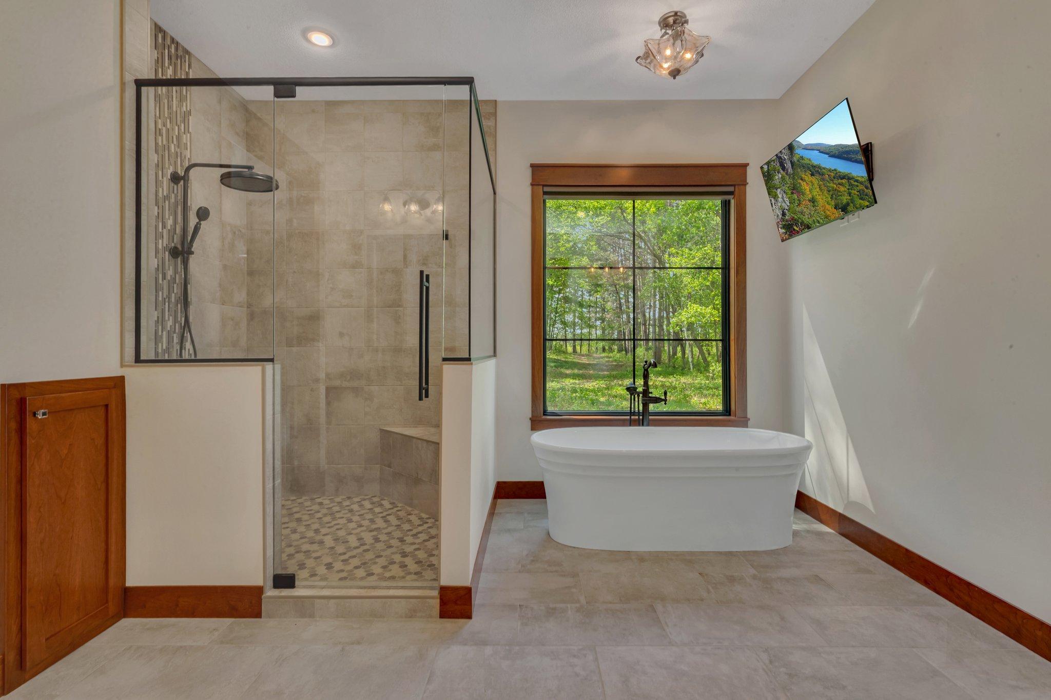 Luxurious custom tile shower paired with a serene soaker tub, creating a spa-like retreat in your bathroom.
