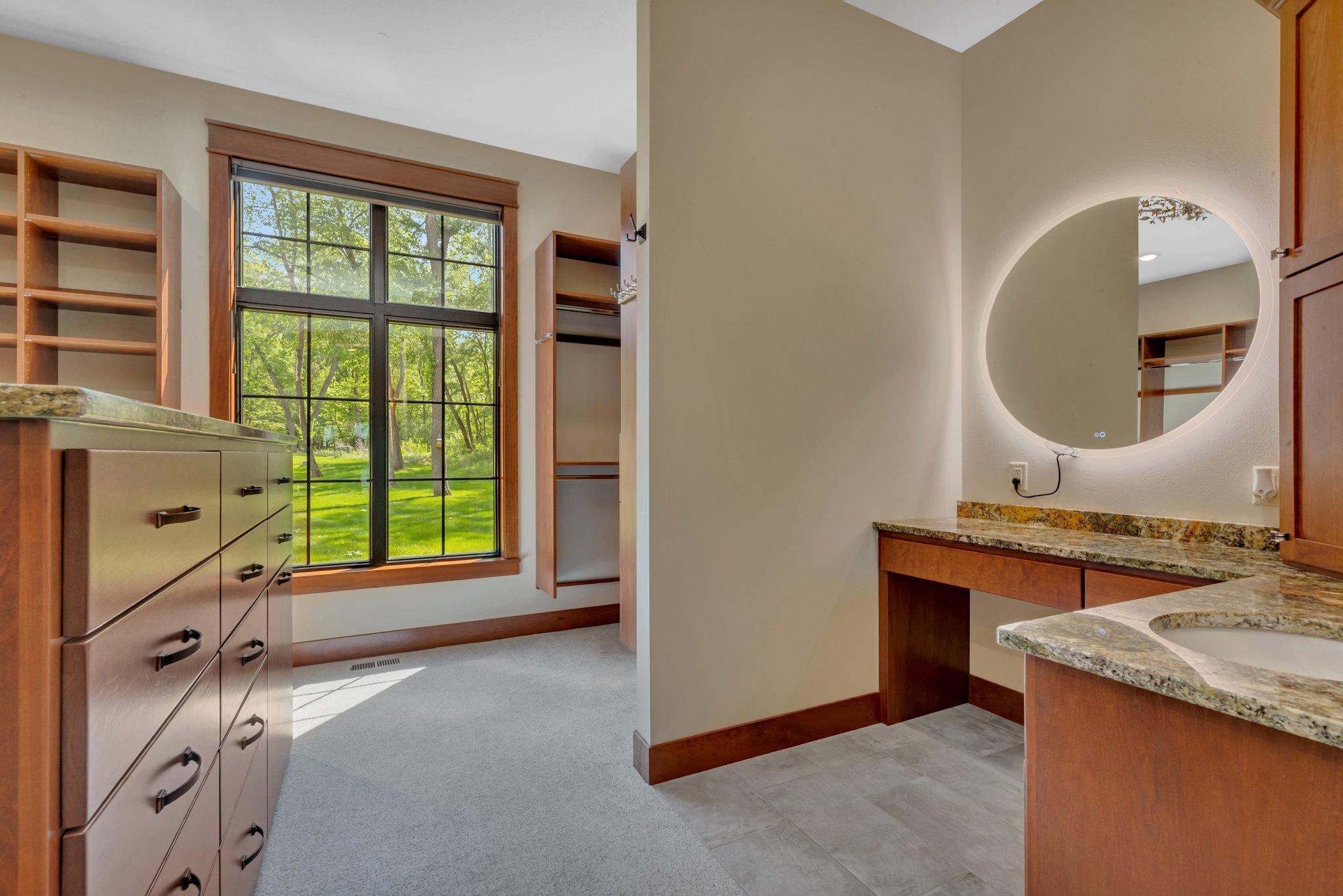 Thoughtfully designed with built-ins, a vanity and island offers seamless storage and functionality.