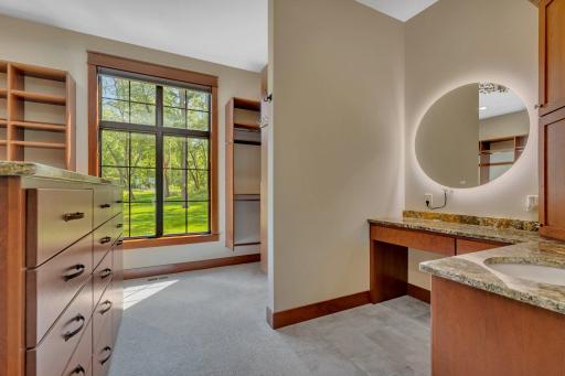 Thoughtfully designed with built-ins, a vanity and island offers seamless storage and functionality.