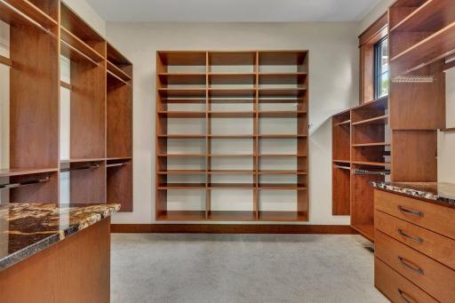 Primary bedroom with two spacious walk-in closets, offering ample storage and convenience.