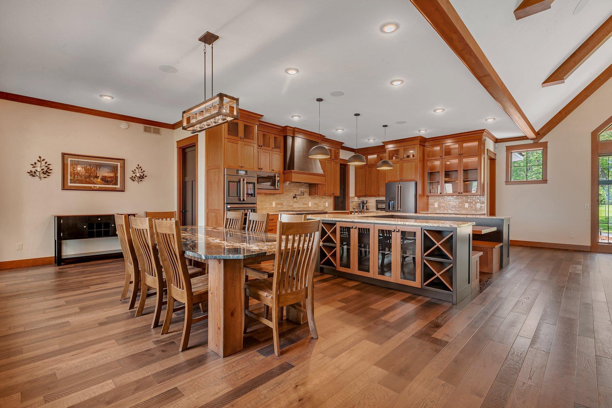 Kitchen dining area featuring spacious seating and a beautiful granite countertop, perfect for family meals or entertaining guests.