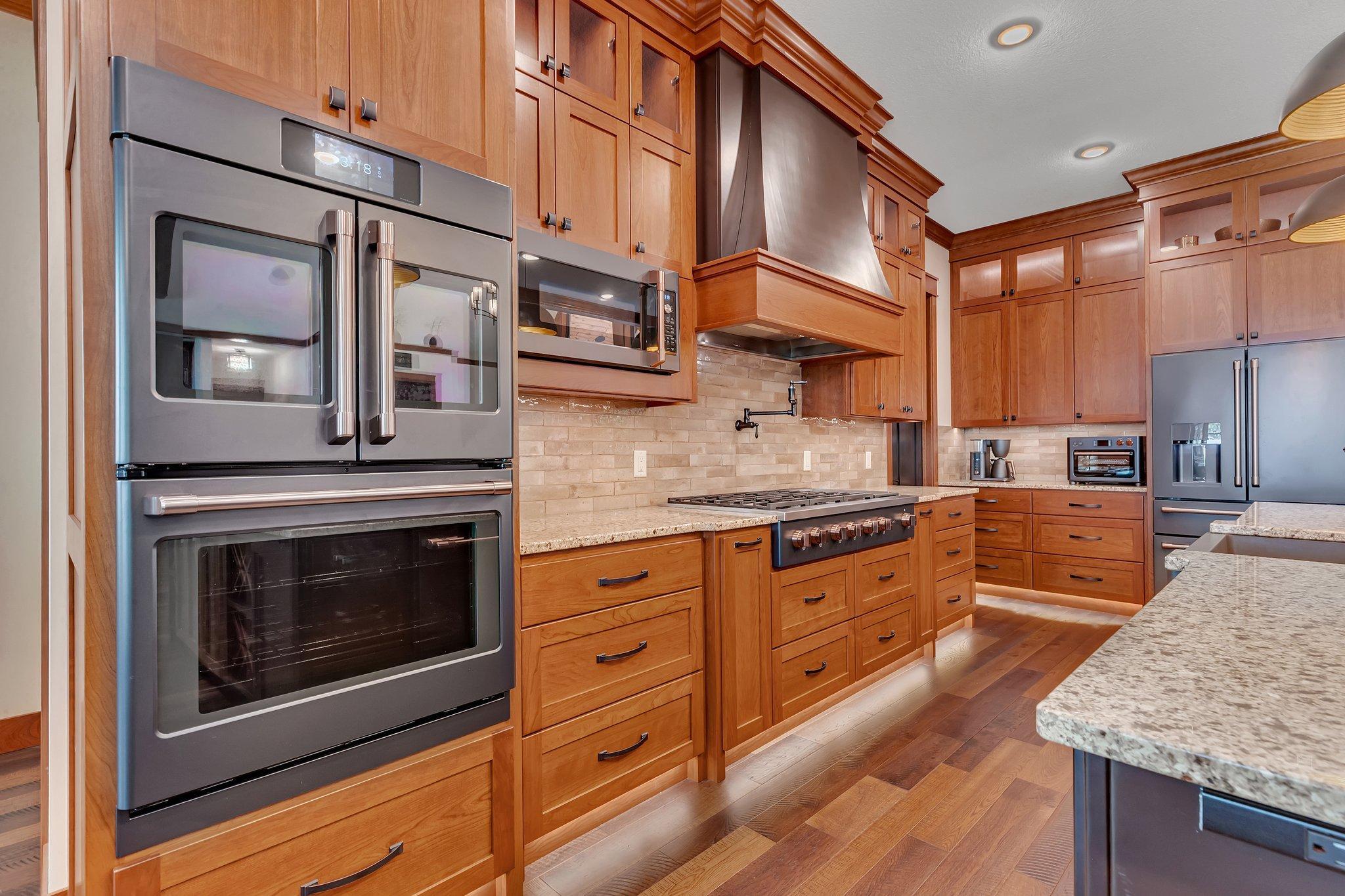 Chef’s kitchen featuring a professional 6-burner gas range with a griddle, perfect for preparing meals with precision and ease.