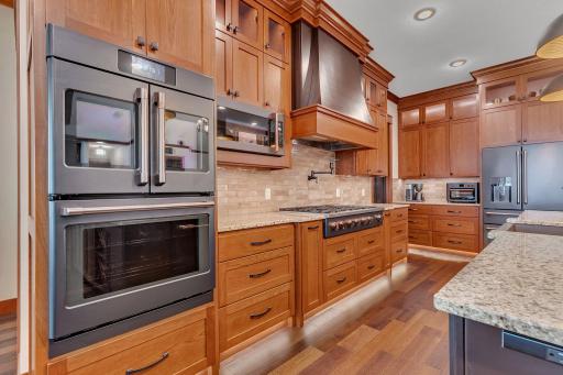Chef’s kitchen featuring a professional 6-burner gas range with a griddle, perfect for preparing meals with precision and ease.